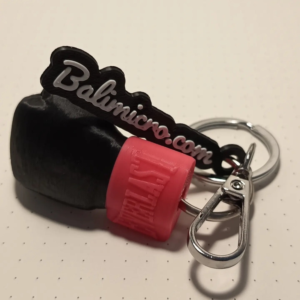 Boxing glove keychain next to a balimicro.com script tag